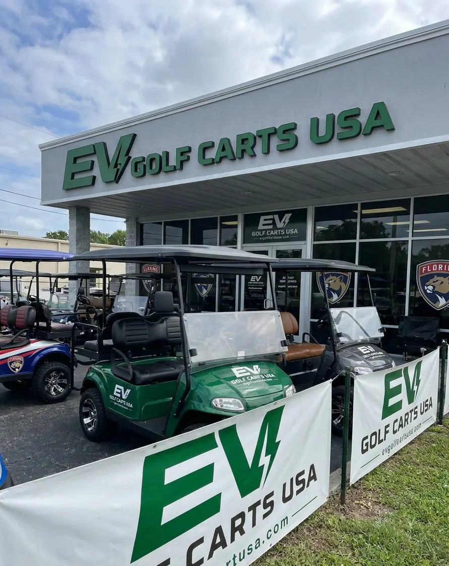 EV Golf Carts USA showroom entrance with a green golf cart and fleet on display