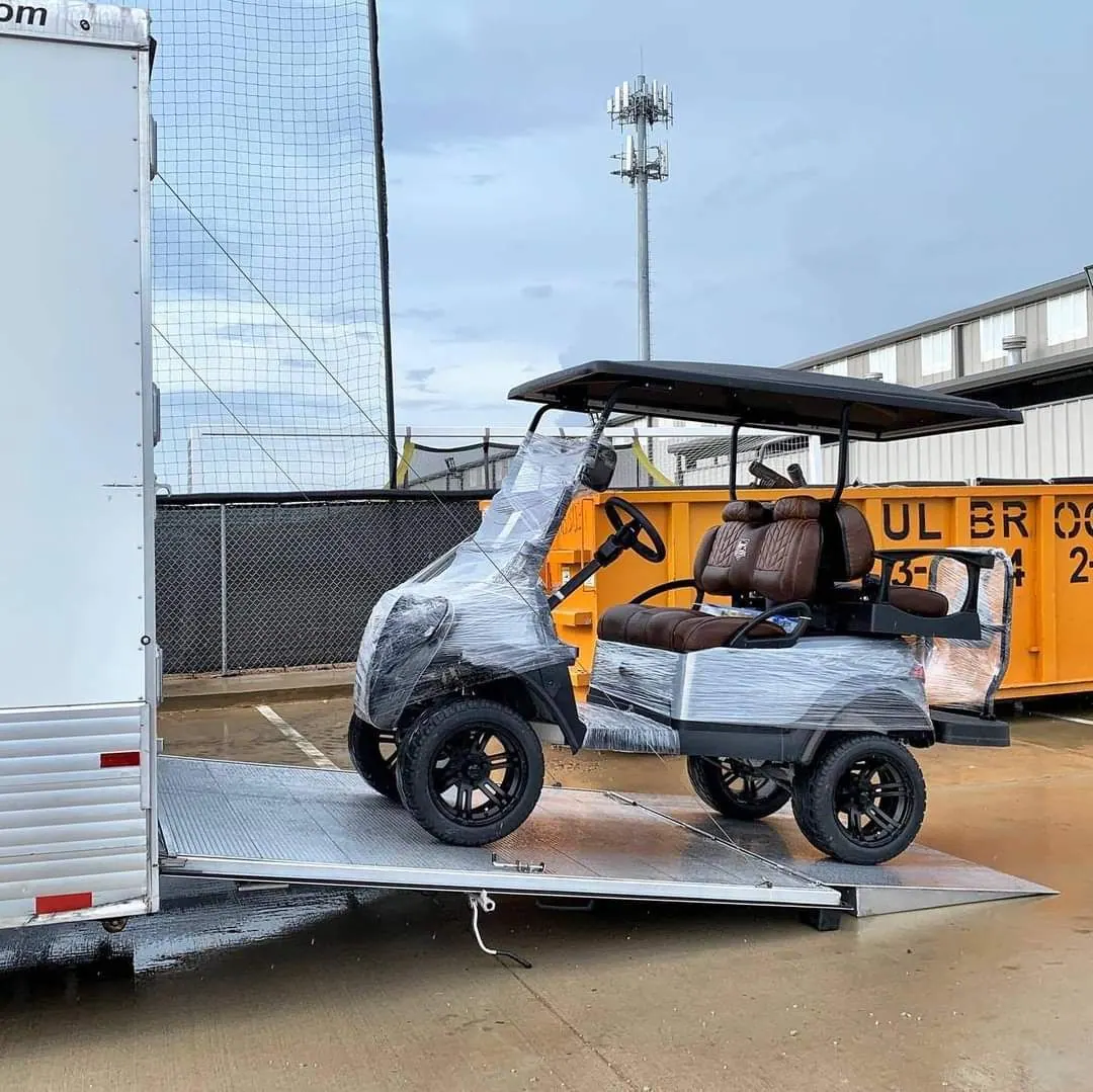 A golf cart being loaded and secured for delivery