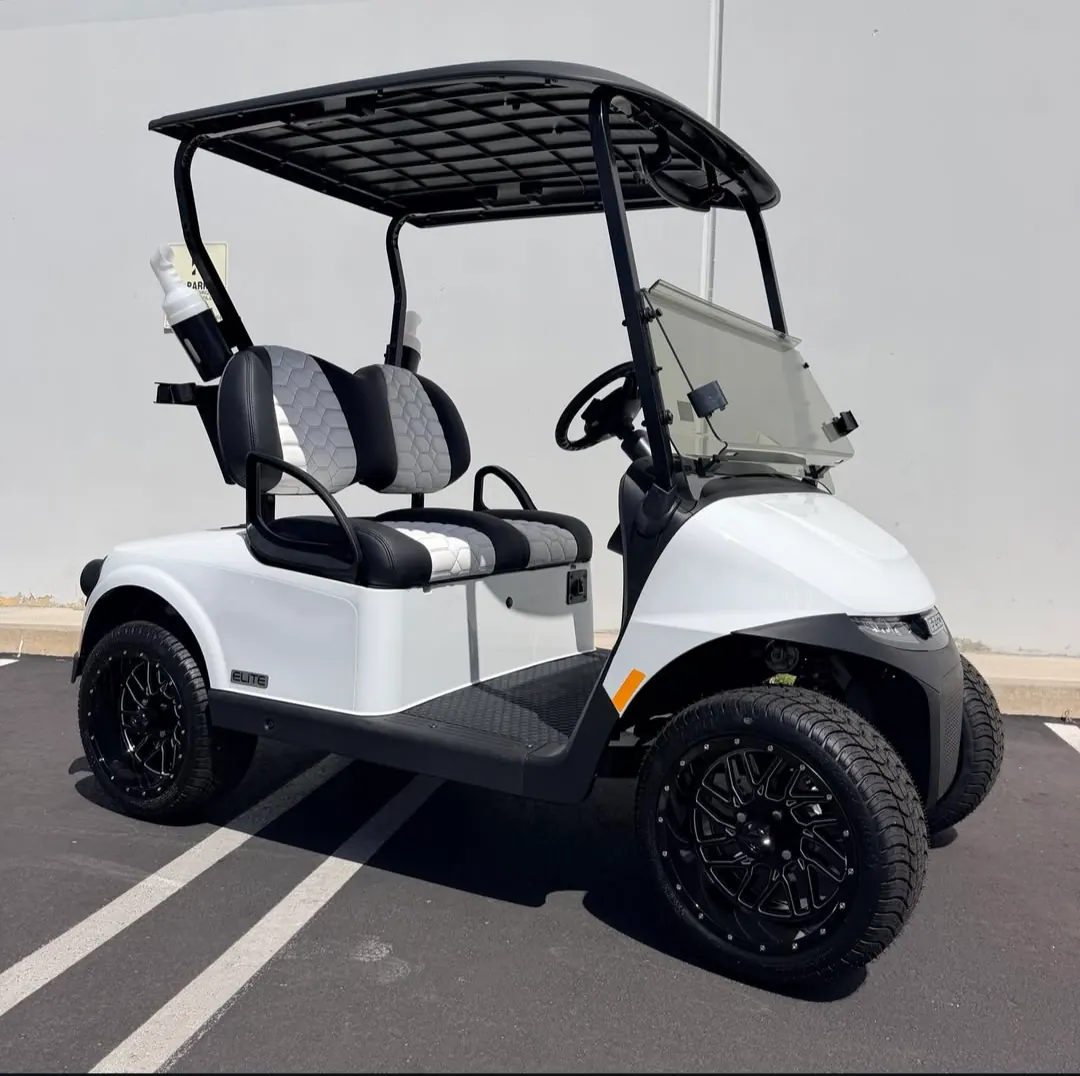 A white golf cart parked against a plain wall