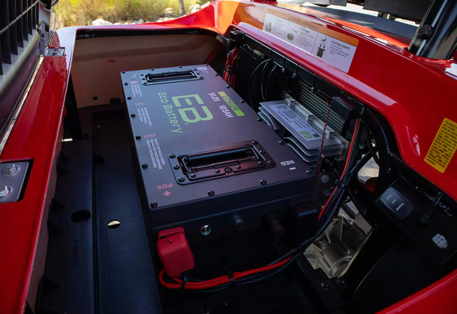 A lithium golf cart battery installed under the hood