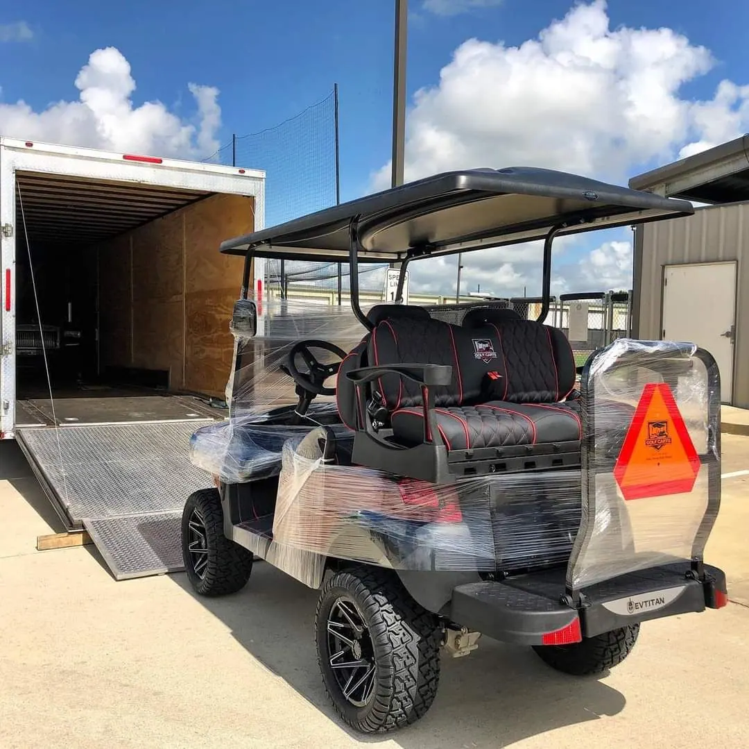 A golf cart wrapped and loaded onto a delivery trailer